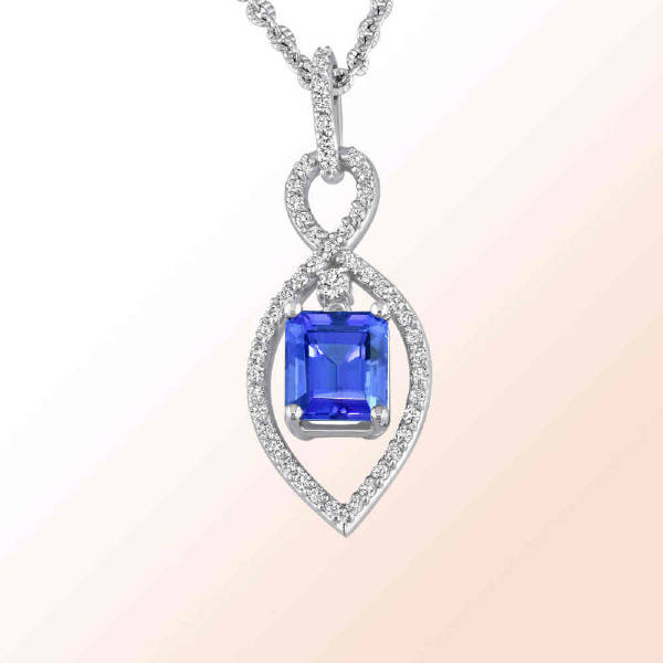 14K.W. PENDATN WITH AN EMERALD CUT TANZANITE WITH DIAMLONDS  3.10CT.